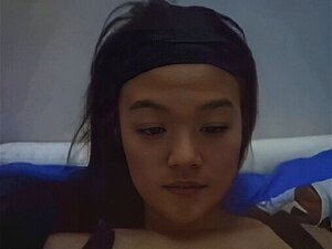 Chica china sexy mostrando sus pequeñas tetas en